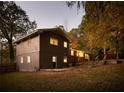 Rear view of a ranch house with gray siding and a large backyard at 3512 Casa Woods Ln, Clarkston, GA 30021