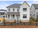 Charming two-story home boasts a welcoming front porch and well-maintained landscaping at 6320 Halcyon Garden Dr, Alpharetta, GA 30005