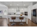 Modern kitchen featuring a large island, stainless steel appliances, and custom cabinetry at 6320 Halcyon Garden Dr, Alpharetta, GA 30005