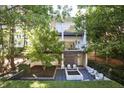 Private backyard oasis with patio and water feature at 9044 Selborne Ln, Chattahoochee Hills, GA 30268