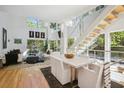 Open concept dining area with hardwood floors and marble table at 9044 Selborne Ln, Chattahoochee Hills, GA 30268
