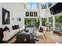 Spacious living room with hardwood floors and large windows at 9044 Selborne Ln, Chattahoochee Hills, GA 30268