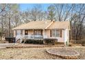 Ranch home with a covered porch and mature trees at 110 Elk Ridge Dr, Social Circle, GA 30025