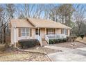 Light beige ranch home with covered porch, and large yard at 110 Elk Ridge Dr, Social Circle, GA 30025