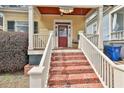 Inviting brick stairs lead to a cozy front porch with a charming porch swing at 725 Oakland Se Ave, Atlanta, GA 30315