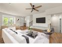 Bright living room featuring a ceiling fan, hardwood floors, and large windows at 1284 Park Bench Pl, Mableton, GA 30126