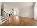 Living room with hardwood floors leading to a kitchen with stainless steel appliances at 1284 Park Bench Pl, Mableton, GA 30126