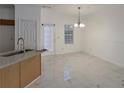 Bright dining area showcases modern lighting, fresh white paint and sleek marble-look tile floors at 5090 Leeshire Trce, Tucker, GA 30084