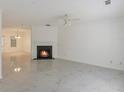 Bright living room featuring a fireplace, fresh white paint, and large-format marble-look tile flooring at 5090 Leeshire Trce, Tucker, GA 30084