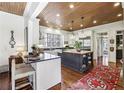 Gourmet kitchen featuring a center island with butcher block countertop and stainless steel appliances at 11461 Hackett Rd, Roswell, GA 30075