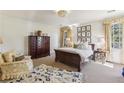 Bedroom featuring a decorative chandelier and windows to let in natural light at 11461 Hackett Rd, Roswell, GA 30075