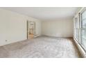 Spacious living area with neutral carpeting and access to other rooms at 1161 Wild Creek Ne Trl, Atlanta, GA 30324