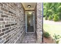 Inviting entryway with brick surround and view into the bright and airy living space at 1442 Casteel Lake Ln # 277, Buford, GA 30518