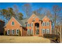 Two-story brick home with a large front yard and mature trees at 5142 Parkwood Oaks Ln, Mableton, GA 30126