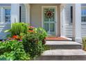 Inviting front porch with lush flowers and a light-green door at 230 Lindbergh Dr, Atlanta, GA 30305