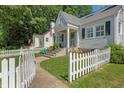 Quaint home with a white picket fence and well-maintained landscaping at 230 Lindbergh Dr, Atlanta, GA 30305