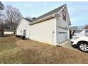 House's side showcasing the garage and additional yard space at 1935 Charleston Oak Cir, Lawrenceville, GA 30043