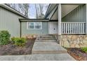 Front entry with stone accents and a covered porch at 1606 Fieldgreen Overlook, Stone Mountain, GA 30088