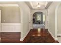 Inviting entryway with hardwood floors, arched doorways, and a view of the living room fireplace at 120 Fountain Oak, Villa Rica, GA 30180