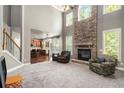 Spacious living room featuring a floor-to-ceiling stone fireplace and large windows at 120 Fountain Oak, Villa Rica, GA 30180