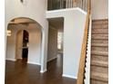 Open-concept entryway with hardwood floors and staircase, creating a bright and inviting space at 1370 Long Acre Dr, Loganville, GA 30052