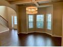 Open-concept living room with large windows and hardwood floors at 1370 Long Acre Dr, Loganville, GA 30052