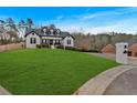 Exterior view of the house with a large front yard and a brick mailbox at 65 Centerport Dr, White, GA 30184