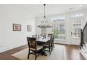 Bright dining room with hardwood floors, chandelier, and seating for six at 6829 Crescendo Ct, Atlanta, GA 30328