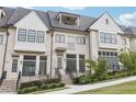 Beautiful townhome with a light-colored brick facade and a well-manicured lawn at 6829 Crescendo Ct, Atlanta, GA 30328
