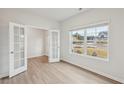 Home office with French doors and large window overlooking the backyard at 1391 Stephens View Dr, Loganville, GA 30052
