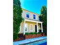 Charming two-story home featuring a welcoming front porch with white columns and well-maintained landscaping at 3236 Tallon Sw Ln, Atlanta, GA 30311