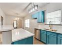 Stylish kitchen with blue cabinets, quartz countertops, stainless steel sink, and modern lighting at 3236 Tallon Sw Ln, Atlanta, GA 30311
