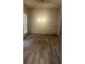 Bright living room featuring hardwood floors and a modern light fixture at 3236 Tallon Sw Ln, Atlanta, GA 30311