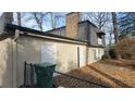 Rear view of the house showing additional garage space and a fenced backyard at 1221 Kenyon Rd, Lake City, GA 30260