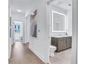 Modern bathroom with a sleek vanity and a large illuminated mirror at 775 Juniper Ne St # 405, Atlanta, GA 30308