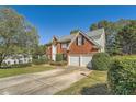 Two-story house with a large driveway and mature trees at 3314 Mill Grove Ter, Dacula, GA 30019