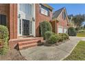 Brick front entrance with stairs leading to a double door at 3314 Mill Grove Ter, Dacula, GA 30019
