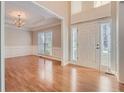 Bright living room with hardwood floors and a view to the foyer at 3314 Mill Grove Ter, Dacula, GA 30019