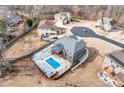 Aerial view of a backyard featuring a swimming pool with a pool deck surrounded by other homes in the neighborhood at 2994 Ash Grv, Conyers, GA 30094