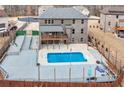 Aerial view showcasing a private in-ground pool with an adjacent deck and fenced yard at 2994 Ash Grv, Conyers, GA 30094