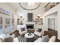 Bright living room featuring a stone fireplace, custom built-ins, and hardwood floors at 3730 Ashford Ne Pt, Brookhaven, GA 30319