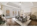 Tranquil main bedroom featuring a stone fireplace, tray ceilings, and access to a private deck at 3730 Ashford Ne Pt, Brookhaven, GA 30319