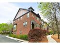 Side view of brick townhome with landscaping and walkway at 67 High Top Ln, Atlanta, GA 30328