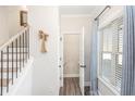 Bright entryway with stairs, half bath, and wood-look floors at 61 Harmony Woods Ln, Dallas, GA 30157