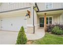 Well-maintained home featuring a black front door, brick accents, and dark exterior lighting fixtures at 61 Harmony Woods Ln, Dallas, GA 30157