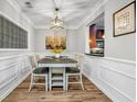 Elegant dining room with wainscoting and a view of the kitchen, featuring modern lighting and neutral decor at 401 16Th Nw St # 1376, Atlanta, GA 30363