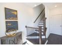 Modern staircase with dark wood and metal railing at 5442 Howington Ct # 191, Buford, GA 30518