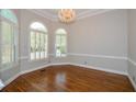 Formal dining room with hardwood floors and large windows at 1431 Olde Forge Ln, Woodstock, GA 30189