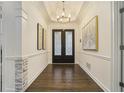 Elegant foyer featuring hardwood floors, decorative doors, and sophisticated lighting fixtures at 201 Windflower Ct, Canton, GA 30115