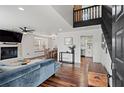 Open-concept living room with hardwood floors, fireplace, and black staircase at 2680 Windage Sw Dr, Marietta, GA 30008